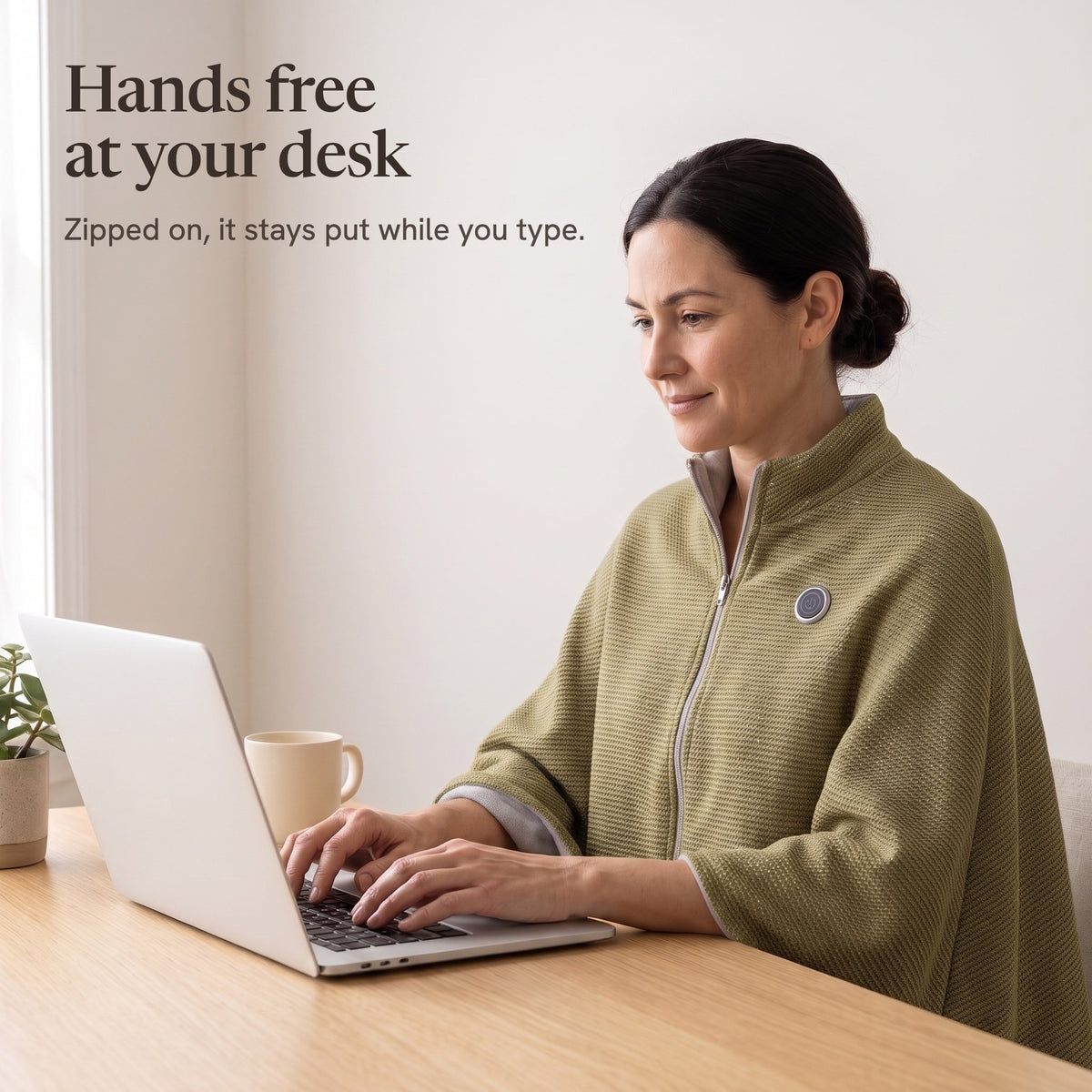 Woman typing at a desk in the olive wrap, hands free