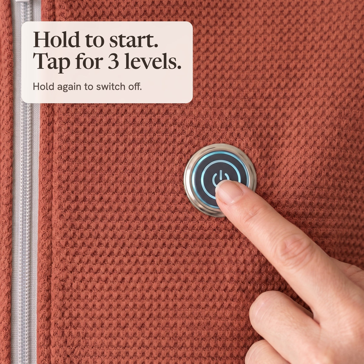 Finger pressing the lit button on the brick red wrap
