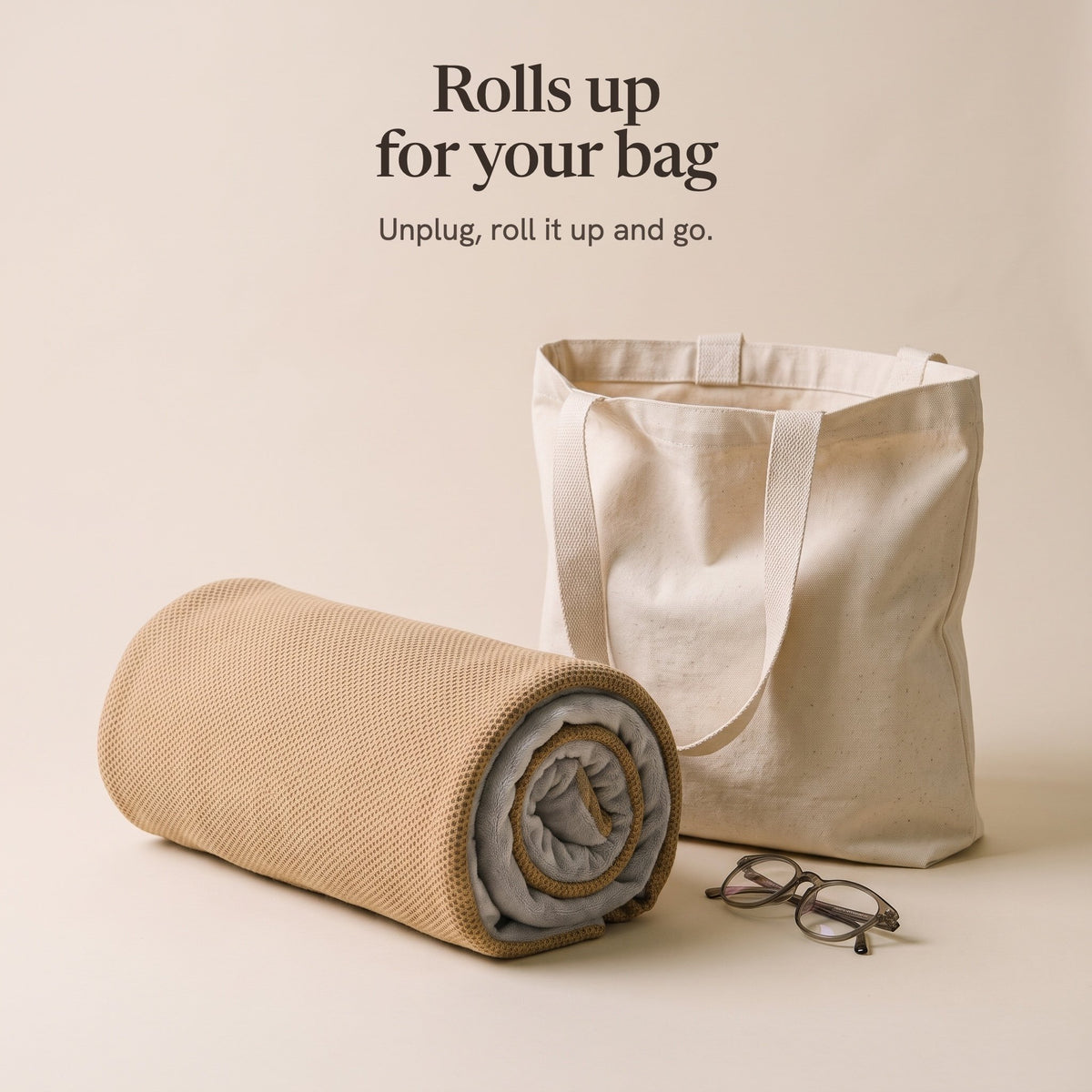 The camel wrap rolled up beside a canvas tote