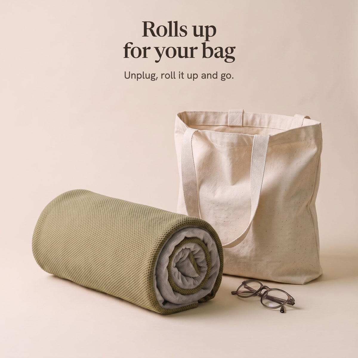The olive wrap rolled up beside a canvas tote