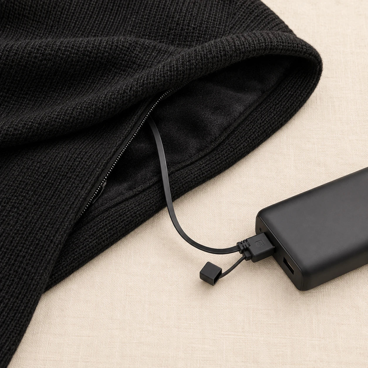 Built-in USB lead connected to a black power bank during setup.